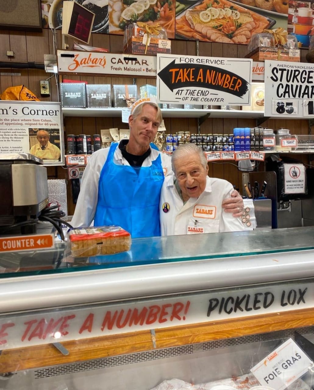 Saul and joe behind counter